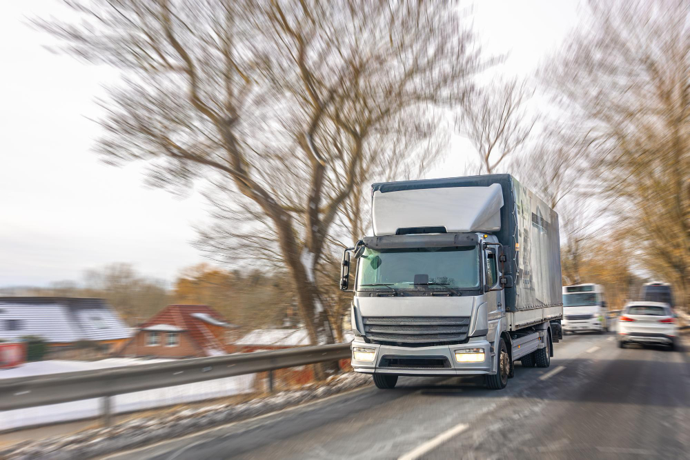 Truck travelling on a road in winter conditions
